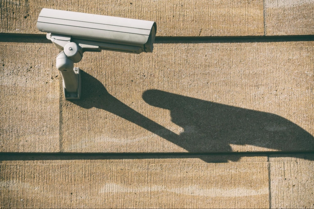 Wall-mounted commercial security camera providing 24/7 video surveillance, installed and monitored by American Security Force professional security services.