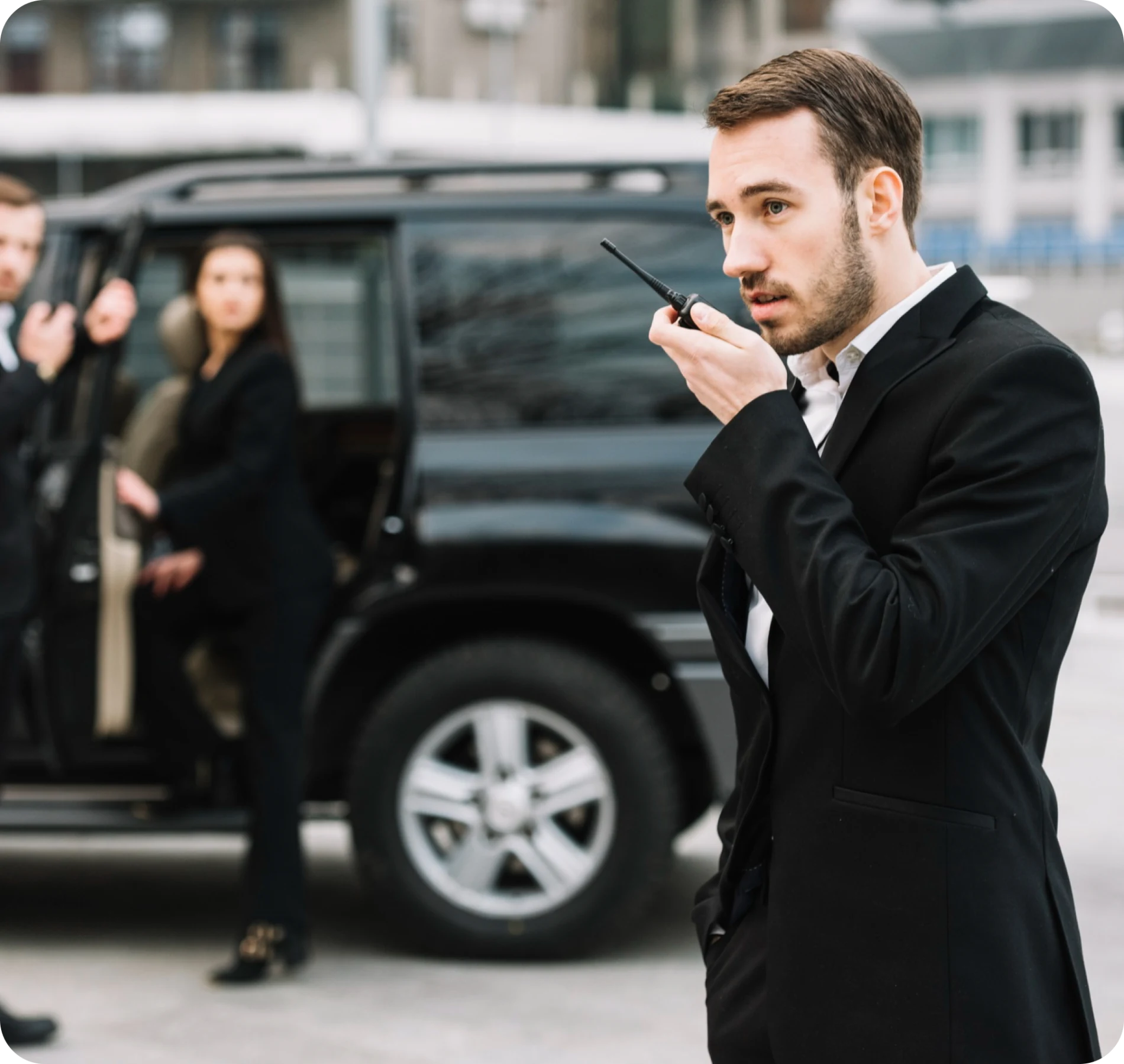 Professional security guard using a radio for communication during executive Security guard services.