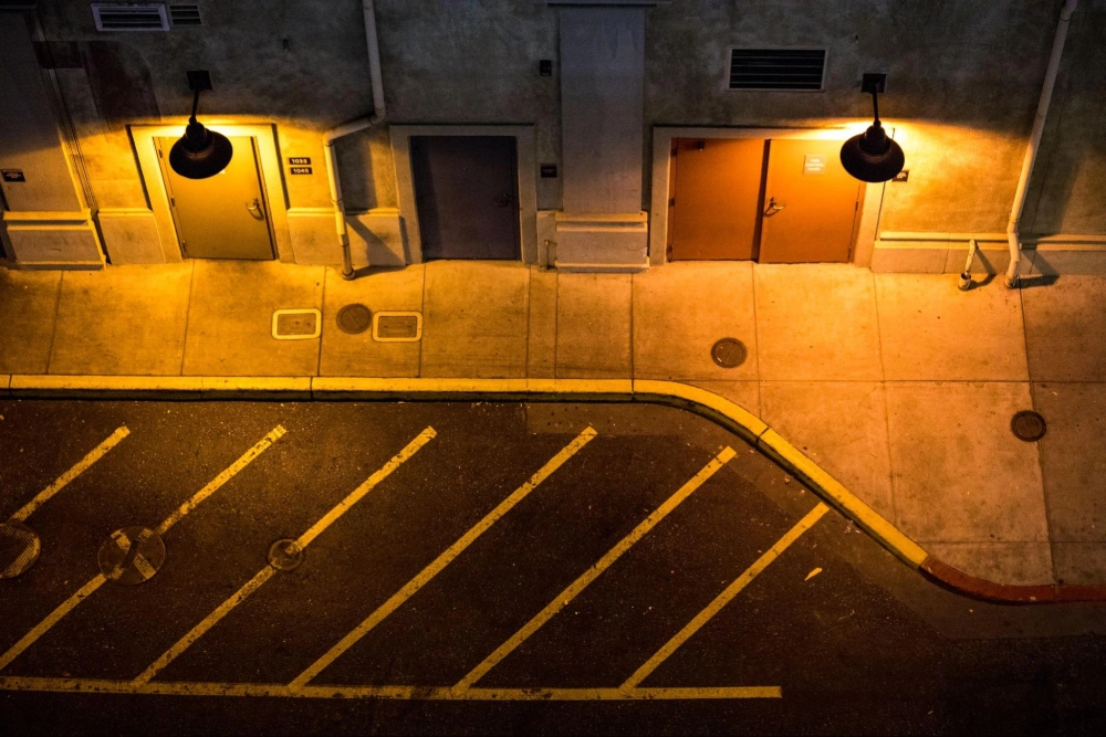 Commercial property security solutions by American Security Force for nighttime protection and safety Nighttime view of a commercial property exterior and parking area, highlighting the need for professional security patrol by American Security Force