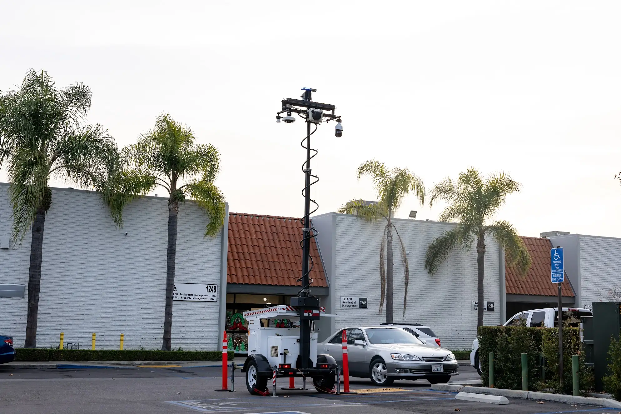 Parking Lot Surveillance Trailer Security | American Security Force Mobile Monitoring Solutions Mobile surveillance trailer with security cameras monitoring a commercial parking lot by American Security Force