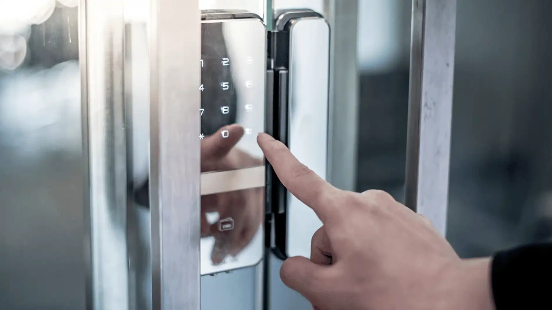Person using a touch-based electronic access control system at a secure door.
